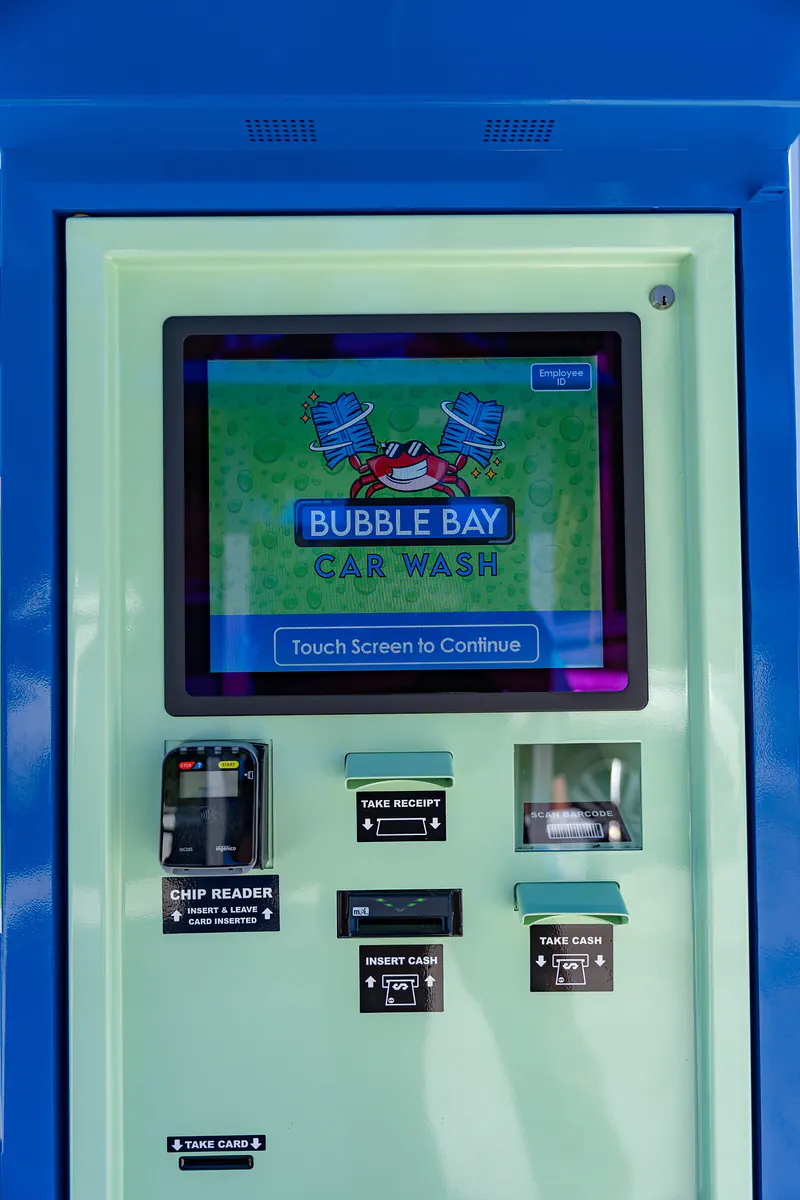 The pay kiosk, its touch screen showing the Bubble Bay logo